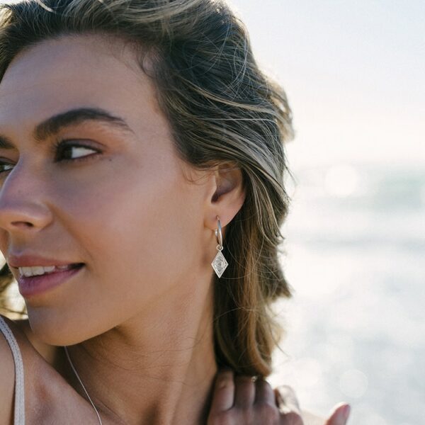 Beautiful woman on beach wearing Larni earings in silver